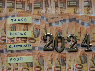 Tasarruf, nakit para ve 2024 yılına ait euro banknotları için çarşaflarda yazılı para geçmişi. Isıtma, elektrik, vergi ve yiyecek için ev bütçesi planlaması. Hayat ve yemek için tasarruf.