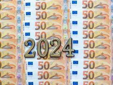 Set of European Union money with a face value of 50 euros. Background of the fifty euros banknotes and 2024 with copy space. Enterprise capital investment, finance, savings, bank and New Year concept