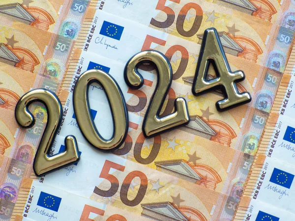 Set of European Union money with a face value of 50 euros. Background of the fifty euros banknotes and 2024 with copy space. Enterprise capital investment, finance, savings, bank and New Year concept