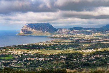 Altında kara bir yağmur bulutu olan güzel bir sahil dağı..