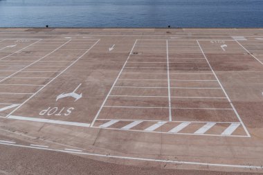 Kocaman boş beton bir otopark, sahil kenarında..