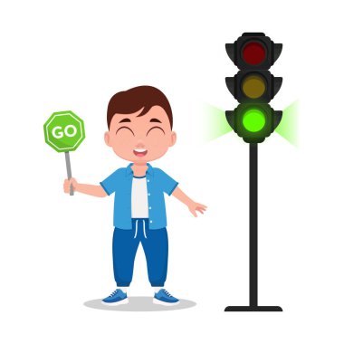 Çocuğun elinde bir işaret var. Trafik ışığı yeşil ışık gösteriyor..
