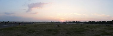 Berlin, Germany, August 8, 2020, evening view over the Tempelhofer Feld with sunset in the background clipart