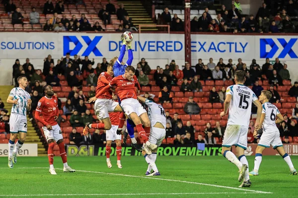 stock image Carl Rushworth #1 of Lincoln City makes a save as Mads Juel Andersen #6 of Barnsley and Robbie Cundy #24 of Barnsley  challenge during the Sky Bet League 1 match Barnsley vs Lincoln City at Oakwell, Barnsley, United Kingdom, 25th October 202