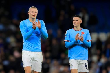 Erling Haaland #9 and Phil Foden #47 of Manchester City celebrate the 2-1 victory at the end of the Premier League match Manchester City vs Fulham at Etihad Stadium, Manchester, United Kingdom, 5th November 202 clipart