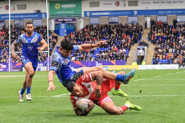 stock image Sione Katoa of Tonga dives in to stop Taylan May of Samoa from going over for a try during the Rugby League World Cup 2021 Quarter Final match Tonga vs Samoa at Halliwell Jones Stadium, Warrington, United Kingdom, 6th November 202