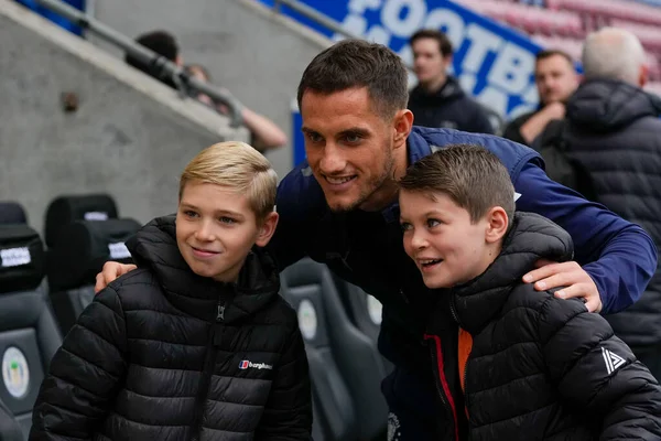 stock image Jerry Yates #9 of Blackpool poses for a photo with a fan before the Sky Bet Championship match Wigan Athletic vs Blackpool at DW Stadium, Wigan, United Kingdom, 12th November 202