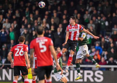 Plymouth Argyle defans oyuncusu Brendan Galloway (22) ve Lincoln City defans oyuncusu Regan Poole (2), Gelder Group Sincil Bank Stadyumu, Lincoln, İngiltere, 12.