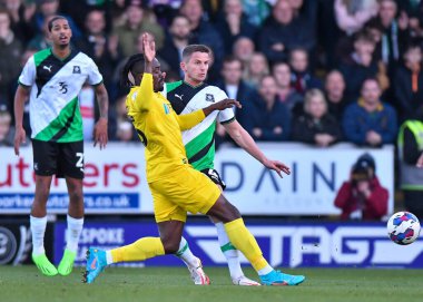 Plymouth Argyle 'ın orta saha oyuncusu Jordan Houghton, 19 Kasım 2022' de İngiltere 'nin başkenti Trent' te oynanan Sky Bet 1 karşılaşmasında Burton Albion ve Plymouth Argyle arasında oynanan maçta Burton Albion forvet oyuncusu Joe Dodoo ile top için mücadele ediyor.