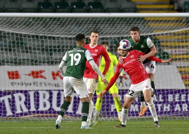 Plymouth Argyle orta saha oyuncusu Jordan Houghton (4) ve Morecambe defans oyuncusu Anthony O 'Connor (22), 17 Aralık 2022' de İngiltere 'nin Plymouth Argyle-Morecambe maçında top için mücadele ettiler.