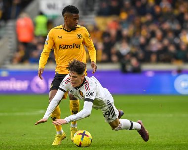 Manchester United 'dan 49 numaralı Alejandro Garnacho, 31 Aralık 2022 tarihinde Wolverhampton Wanderers' a karşı Manchester United 'ın Molineux, Wolverhampton, Birleşik Krallık maçında 22 numaralı Wolverhampton Wanderers maçı sırasında Nlson Semedo tarafından faul yaptı.