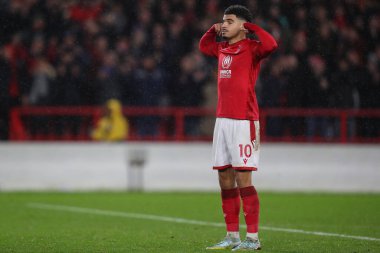 Morgan Gibbs-White #10 of Nottingham Forest puts his fingers in his ears and celebrates scoring his penalty in the shootout during the Carabao Cup Quarter Final match Nottingham Forest vs Wolverhampton Wanderers at City Ground, Nottingham, United Kin