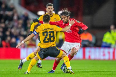 Gustavo Scarpa #31 of Nottingham Forest looks for a way round Joao Moutinho #28 of Wolverhampton Wanderers during the Carabao Cup Quarter Final match Nottingham Forest vs Wolverhampton Wanderers at City Ground, Nottingham, United Kingdom, 11th Januar
