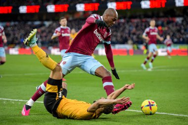 Matheus Cunha #12 of Wolverhampton Wanderers goes down under a challenge from Angelo Ogbonna #21 of West Ham United during the Premier League match Wolverhampton Wanderers vs West Ham United at Molineux, Wolverhampton, United Kingdom, 14th January 20