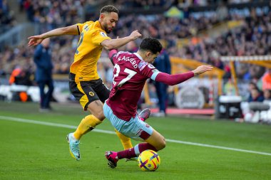 Nayef Aguerd #27 of West Ham United challenges for the ball with Matheus Cunha #12 of Wolverhampton Wanderers during the Premier League match Wolverhampton Wanderers vs West Ham United at Molineux, Wolverhampton, United Kingdom, 14th January 202