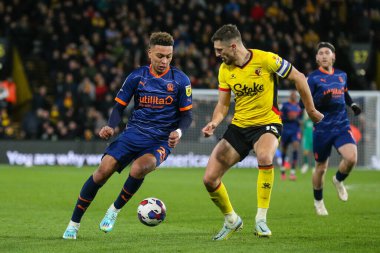 Morgan Rogers #25 of Blackpool runs at Craig Cathcart #15 of Watford during the Sky Bet Championship match Watford vs Blackpool at Vicarage Road, Watford, United Kingdom, 14th January 202