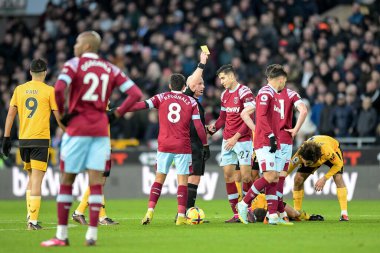 Nayef Aguerd #27 of West Ham United receives a yellow card from /referee Simon Hooper for his foul on Joao Moutinho #28 of Wolverhampton Wanderers during the Premier League match Wolverhampton Wanderers vs West Ham United at Molineux, Wolverhampton, 