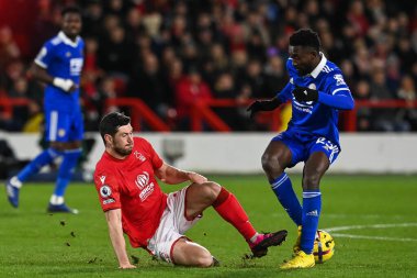 Wilfred Ndidi #25 of Leicester City is tackled by Scott McKenna #26 of Nottingham Forest during the Premier League match Nottingham Forest vs Leicester City at City Ground, Nottingham, United Kingdom, 14th January 202
