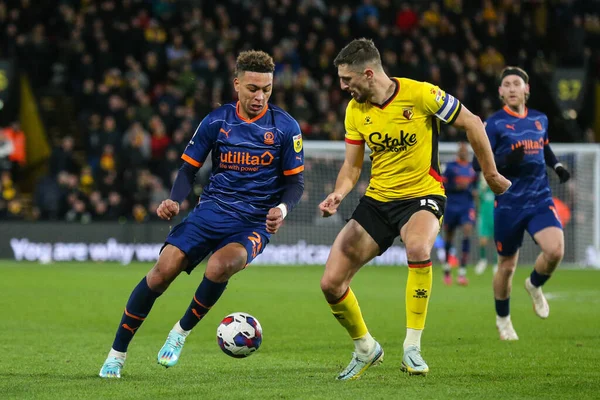 Morgan Rogers #25 of Blackpool runs at Craig Cathcart #15 of Watford during the Sky Bet Championship match Watford vs Blackpool at Vicarage Road, Watford, United Kingdom, 14th January 202