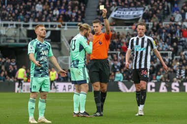 Tim Ream #13 of Fulham receives a yellow card from referee Robert Jones during the Premier League match Newcastle United vs Fulham at St. James's Park, Newcastle, United Kingdom, 15th January 202