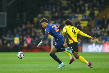 Morgan Rogers #25 of Blackpool and Hamza Choudhury #4 of Watford tussle for the ball during the Sky Bet Championship match Watford vs Blackpool at Vicarage Road, Watford, United Kingdom, 14th January 202