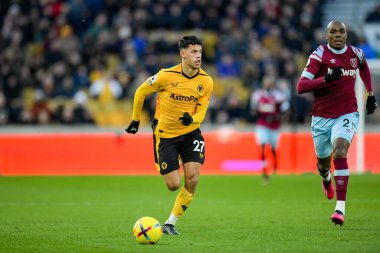 Matheus Nunes #27 of Wolverhampton Wanderers makes a run with the ball chased by Angelo Ogbonna #21 of West Ham United during the Premier League match Wolverhampton Wanderers vs West Ham United at Molineux, Wolverhampton, United Kingdom, 14th January