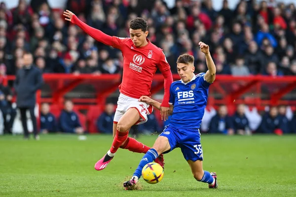 Brennan Johnson #20 of Nottingham Forest is tackled by Luke Thomas #33 of Leicester City during the Premier League match Nottingham Forest vs Leicester City at City Ground, Nottingham, United Kingdom, 14th January 202