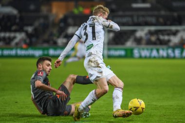 Joe Williams #8 of Bristol City tackles Ollie Cooper #31 of Swansea City during the Emirates FA Cup Third Round Replay match Swansea City vs Bristol City at Swansea.com Stadium, Swansea, United Kingdom, 17th January 202