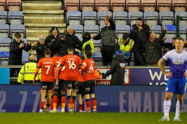 Luton Town players celebrate their winning goal in front of the travelling Hatters fans during the Emirates FA Cup match Third Round Replay Wigan Athletic vs Luton Town at DW Stadium, Wigan, United Kingdom, 17th January 202
