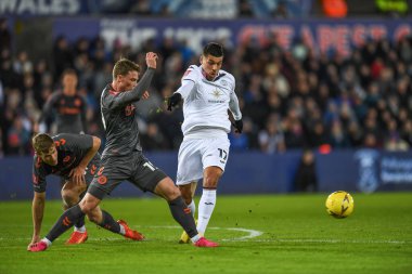 Jol Piroe #17 of Swansea City tackled by George Tanner #19 of Bristol City during the Emirates FA Cup Third Round Replay match Swansea City vs Bristol City at Swansea.com Stadium, Swansea, United Kingdom, 17th January 2023