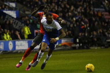 Elijah Adebayo #11 of Luton Town competes for the ball with Curtis Tilt #16 of Wigan Athletic  during the Emirates FA Cup match Third Round Replay Wigan Athletic vs Luton Town at DW Stadium, Wigan, United Kingdom, 17th January 202