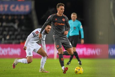 Kal Naismith #4 of Bristol City Under pressure from Matt Grimes #8 of Swansea City during the Emirates FA Cup Third Round Replay match Swansea City vs Bristol City at Swansea.com Stadium, Swansea, United Kingdom, 17th January 202