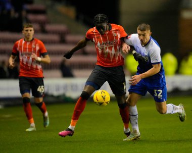 Elijah Adebayo #11 of Luton Town competes for the ball with Charlie Hughes #32 of Wigan Athletic during the Emirates FA Cup match Third Round Replay Wigan Athletic vs Luton Town at DW Stadium, Wigan, United Kingdom, 17th January 202