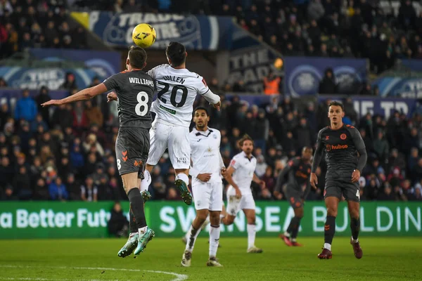 Liam Cullen #20 of Swansea City and Joe Williams #8 of Bristol City compete the high ball during the Emirates FA Cup Third Round Replay match Swansea City vs Bristol City at Swansea.com Stadium, Swansea, United Kingdom, 17th January 202