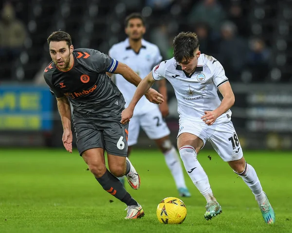 Luke Cundle #18 of Swansea City  takes on Matthew James #6 of Bristol City during the Emirates FA Cup Third Round Replay match Swansea City vs Bristol City at Swansea.com Stadium, Swansea, United Kingdom, 17th January 202