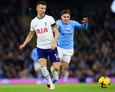 Ivan Perisic #14 of Tottenham Hotspur passes the ball under pressure from Julian Alvarez #19 of Manchester City during the Premier League match Manchester City vs Tottenham Hotspur at Etihad Stadium, Manchester, United Kingdom, 19th January 202