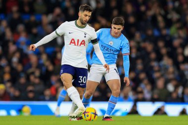 Rodrigo Bentancur #30 of Tottenham Hotspur passes the ball under pressure from Julian Alvarez #19 of Manchester City during the Premier League match Manchester City vs Tottenham Hotspur at Etihad Stadium, Manchester, United Kingdom, 19th January 202