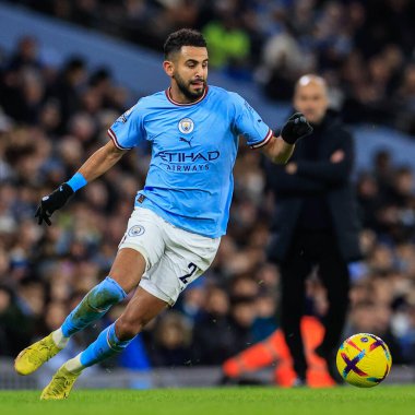 Riyad Mahrez #26 of Manchester City in action with Pep Guardiola manager of Manchester City looking on during the Premier League match Manchester City vs Tottenham Hotspur at Etihad Stadium, Manchester, United Kingdom, 19th January 202