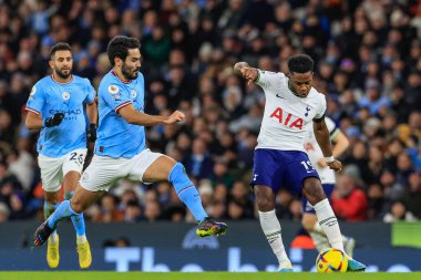 Ryan Sessegnon #19 of Tottenham Hotspur passes the ball as lkay Gndoan #8 of Manchester City dives in during the Premier League match Manchester City vs Tottenham Hotspur at Etihad Stadium, Manchester, United Kingdom, 19th January 2023