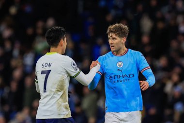 Son Heung-Min #7 of Tottenham Hotspur shakes hands with John Stones #5 of Manchester City after City win 4-2 during the Premier League match Manchester City vs Tottenham Hotspur at Etihad Stadium, Manchester, United Kingdom, 19th January 202