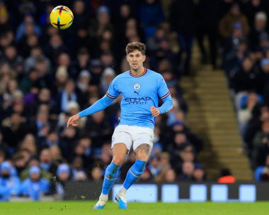 John Stones #5 of Manchester City passes the ball during the Premier League match Manchester City vs Tottenham Hotspur at Etihad Stadium, Manchester, United Kingdom, 19th January 202