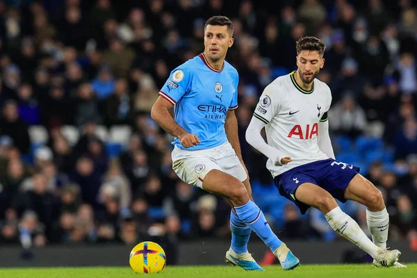Rodri #16 of Manchester City holds the ball as Rodrigo Bentancur #30 of Tottenham Hotspur tracks him during the Premier League match Manchester City vs Tottenham Hotspur at Etihad Stadium, Manchester, United Kingdom, 19th January 202