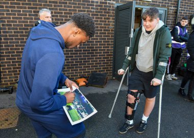 Plymouth Argyle full back Bali Mumba  (17)  sign the picture for a young fan who broke his knee celebrating Plymouth Argyle full back Bali Mumba  (17)  goal in Ipswich Town during the Sky Bet League 1 match Plymouth Argyle vs Cheltenham Town at Home 