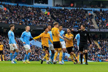 Players of both teams remonstrate with referee David Coote during the Premier League match Manchester City vs Wolverhampton Wanderers at Etihad Stadium, Manchester, United Kingdom, 22nd January 202