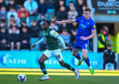 Plymouth Argyle midfielder Jay Matete (28)  goes past Cheltenham Town forward Will Goodwin (9)  during the Sky Bet League 1 match Plymouth Argyle vs Cheltenham Town at Home Park, Plymouth, United Kingdom, 21st January 202