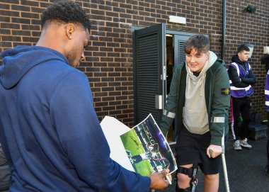 Plymouth Argyle full back Bali Mumba  (17)  sign the picture for a young fan who broke his knee celebrating Plymouth Argyle full back Bali Mumba  (17)  goal in Ipswich Town  during the Sky Bet League 1 match Plymouth Argyle vs Cheltenham Town at Home