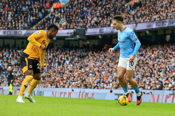 Jack Grealish #10 of Manchester City is confronted by Nelson Semedo #22 of Wolverhampton Wanderers during the Premier League match Manchester City vs Wolverhampton Wanderers at Etihad Stadium, Manchester, United Kingdom, 22nd January 202