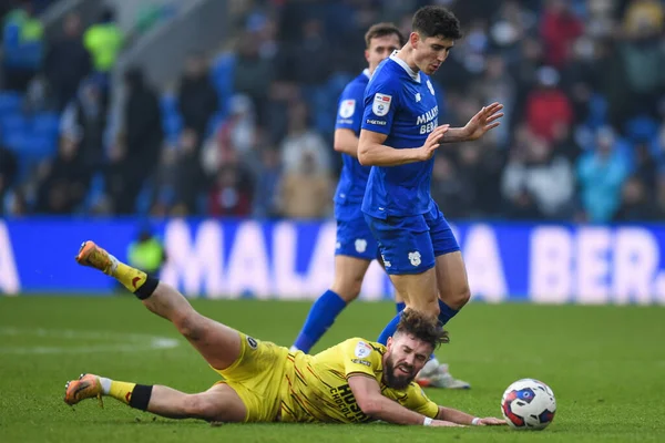 Tom Bradshaw #9 of Millwall goes down under pressure from Callum O'Dowda #11 of Cardiff City  during the Sky Bet Championship match Cardiff City vs Millwall at Cardiff City Stadium, Cardiff, United Kingdom, 21st January 202