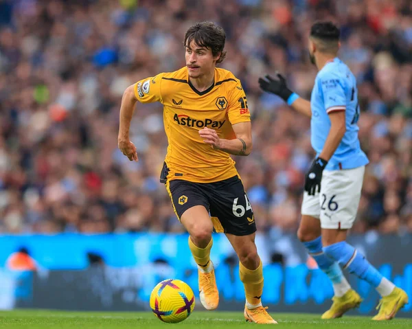 Hugo Bueno #64 of Wolverhampton Wanderers runs with the ball during the Premier League match Manchester City vs Wolverhampton Wanderers at Etihad Stadium, Manchester, United Kingdom, 22nd January 202