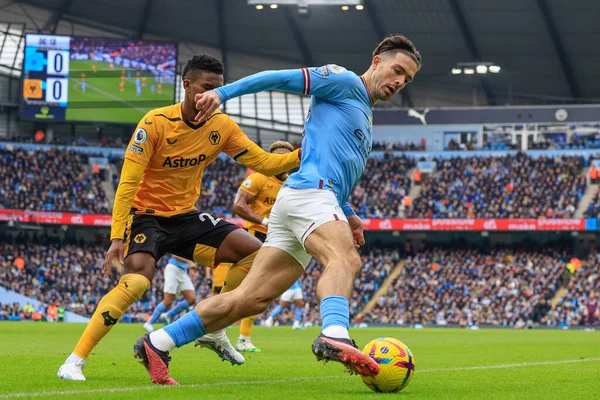 Jack Grealish #10 of Manchester City controls the ball under pressure from Nlson Semedo #22 of Wolverhampton Wanderers during the Premier League match Manchester City vs Wolverhampton Wanderers at Etihad Stadium, Manchester, United Kingdom